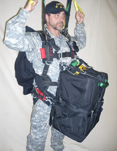 Man posing with Heavy Load Tactical parachute gear