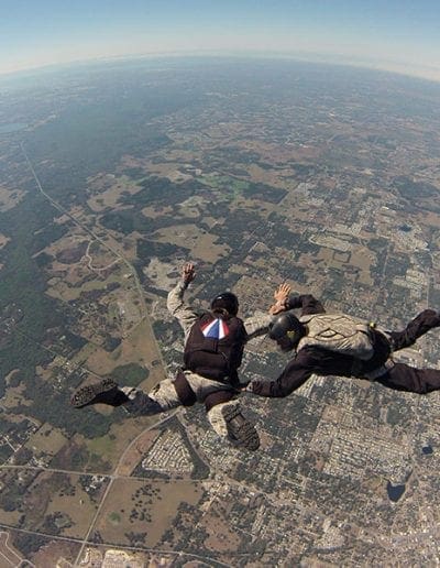 Instructor assisting student in freefall