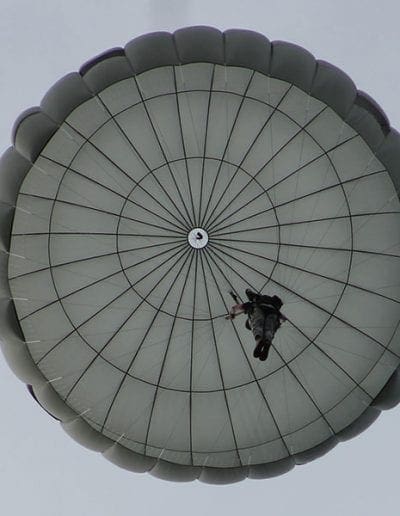 Looking directly up at a descending Invasion II Non-Steerable parachute